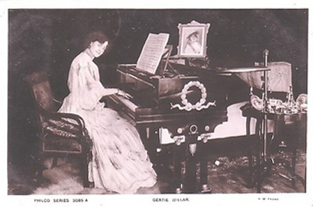 Gertie Millar playing a grand piano (image)